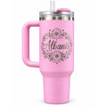Pink handled tumbler with a laser engraved daisy and wildflower wreath around a personalized script name